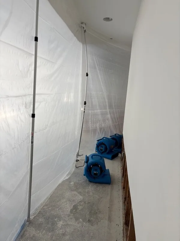 Basement water damage containment barrier