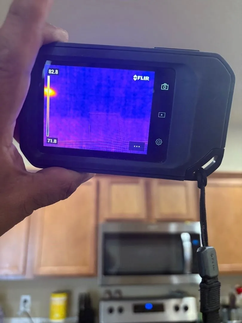 Thermal imaging camera showing hidden moisture in the ceiling during leak diagnosis